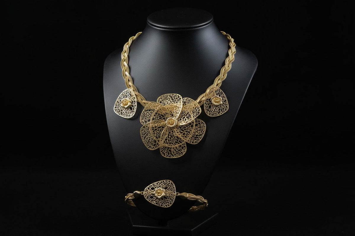 Gold floral jewelry set including bracelet, ring, and earrings by BENTIX featuring intricate plaited design and Brazilian gold accents.