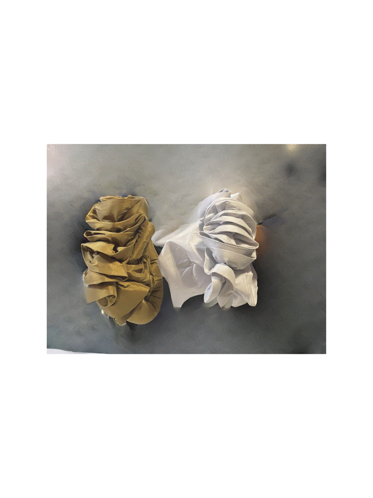 White floral Nigerian turban with gold scrunchie, stylish headwrap accessory by BENTIX, featuring intricate floral patterns.
