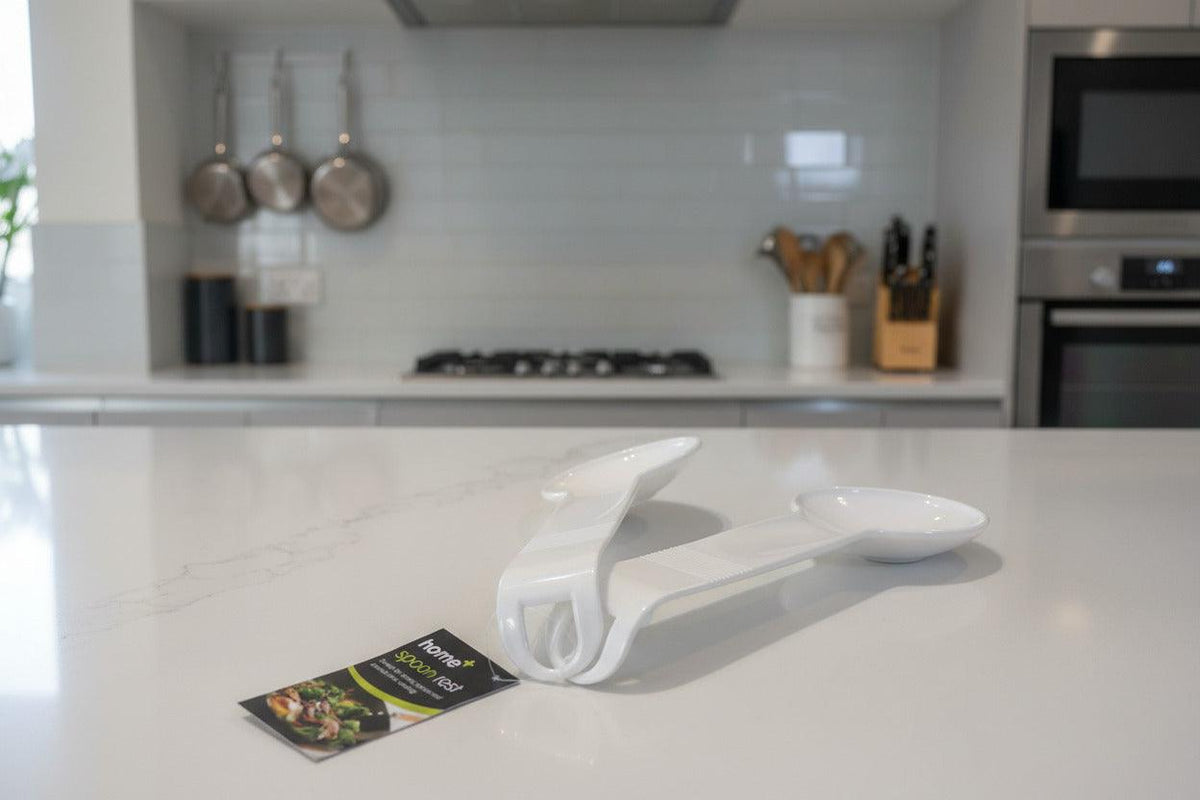Set of two BENTIX plastic serving spoons with matching spoon rests, ideal for serving and table presentation.