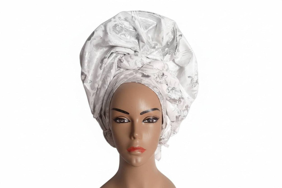White and silver Nigerian auto-Gele headtie by Bentix, showcasing intricate traditional design and elegant styling.