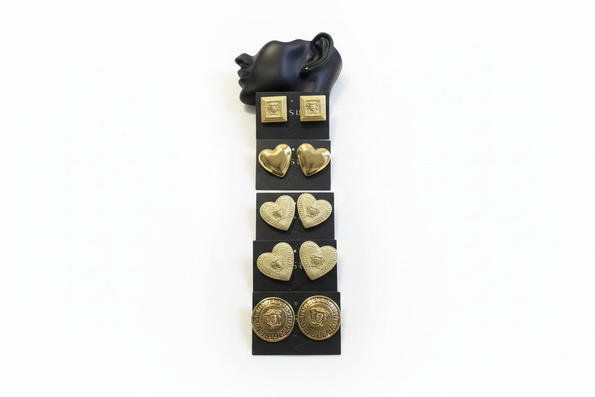 Set of Bentix Brazilian gold earrings in various shapes, including heart-shaped coins displayed on clear plastic cards.