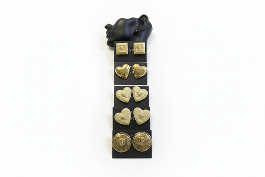 Set of Bentix Brazilian gold earrings in various shapes, including heart-shaped coins displayed on clear plastic cards.
